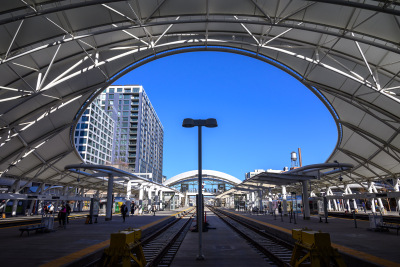 Giant oval opening exposes a bright blue sky from the end of the train platform at Union Station in Denver, Colorado.