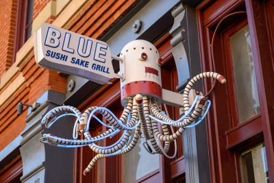 A neon robot octopus greets visitors to a restaurant in downtown Denver.