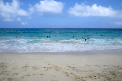 People enjoy the calm blue ocean waters at Maniniowali Beach near Kona, Hawaii