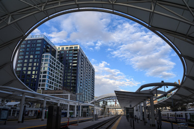 Fluffy white clouds fill the round hole in the roof above the train platforms at Union Station in Denver, Colorado.
