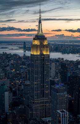 The Empire State Building stands out in front of a Manhattan Sunset seen from One Vanderbilt in New York City.