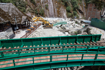 Green bridges cross a rocky construction site in Aguas Calientes