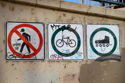 Graffiti decorates a sign along the Cherry Creek Trail in downtown Denver, Colorado.