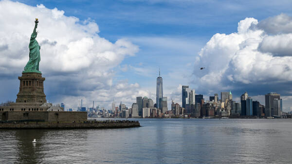 The Statue of Liberty rises above lower Manhattan