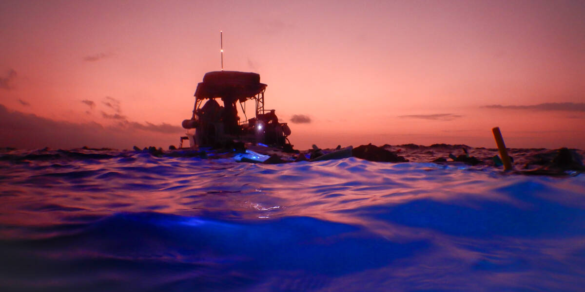 A vibrant sunset seen from Hoona Bay near Kona during a manata ray snorkeling excursion in Hawaii