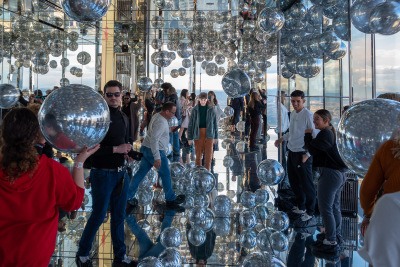 Telekinetic young woman mentally manipulates dozens of  mylar balloons at the One Vanderbilt building in New York City.