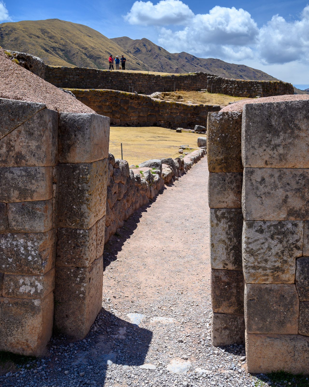 View through a stone gateway into the Red Fortress ruins outside Cusco