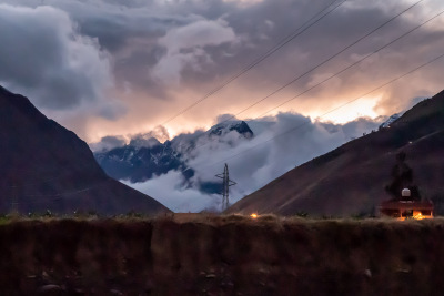 Fiery sunset between two mountains seen from Ollantaytambo, Peru.