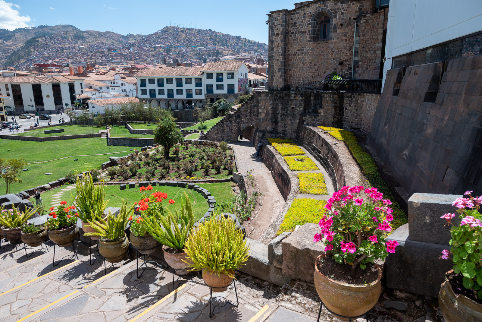 Green area with flower pots outside Qorikancha