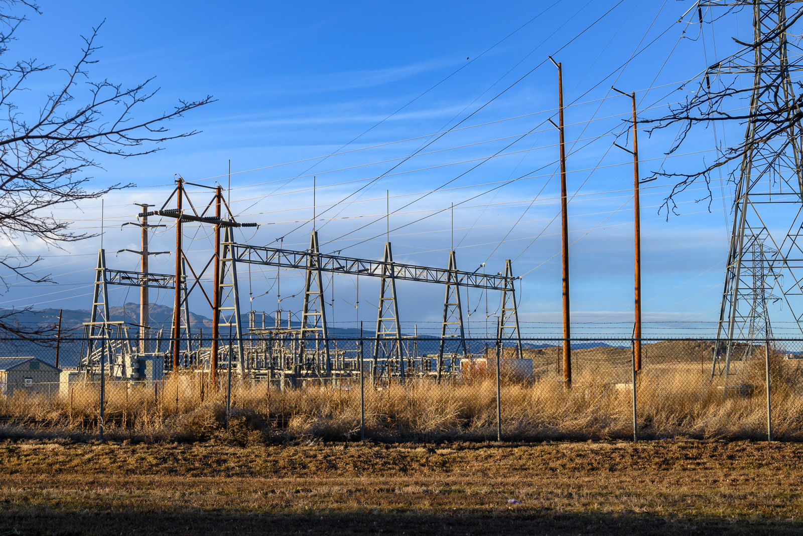 Power poles, transmission towers and electric lines converge at an electric substation near Valmont Power Plant in Boulder, Colorado.