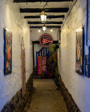 Signs line a hallway in Cusco leading to both sushi and massages.