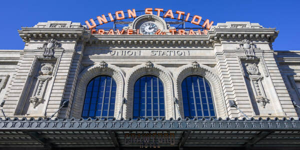 Closeup wide shot of Union Station in Denver Colorado featuring historic neon sign and clock.