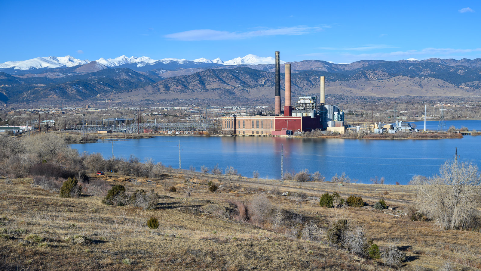 Valmont station power plant sits between the resevoir and the snow-capped Rocky Mountains in Boulder, Colorado.