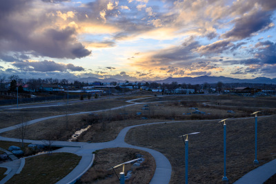 The sun sets over the Rocky Mountains seen from Westminster Station near Denver, Colorado.