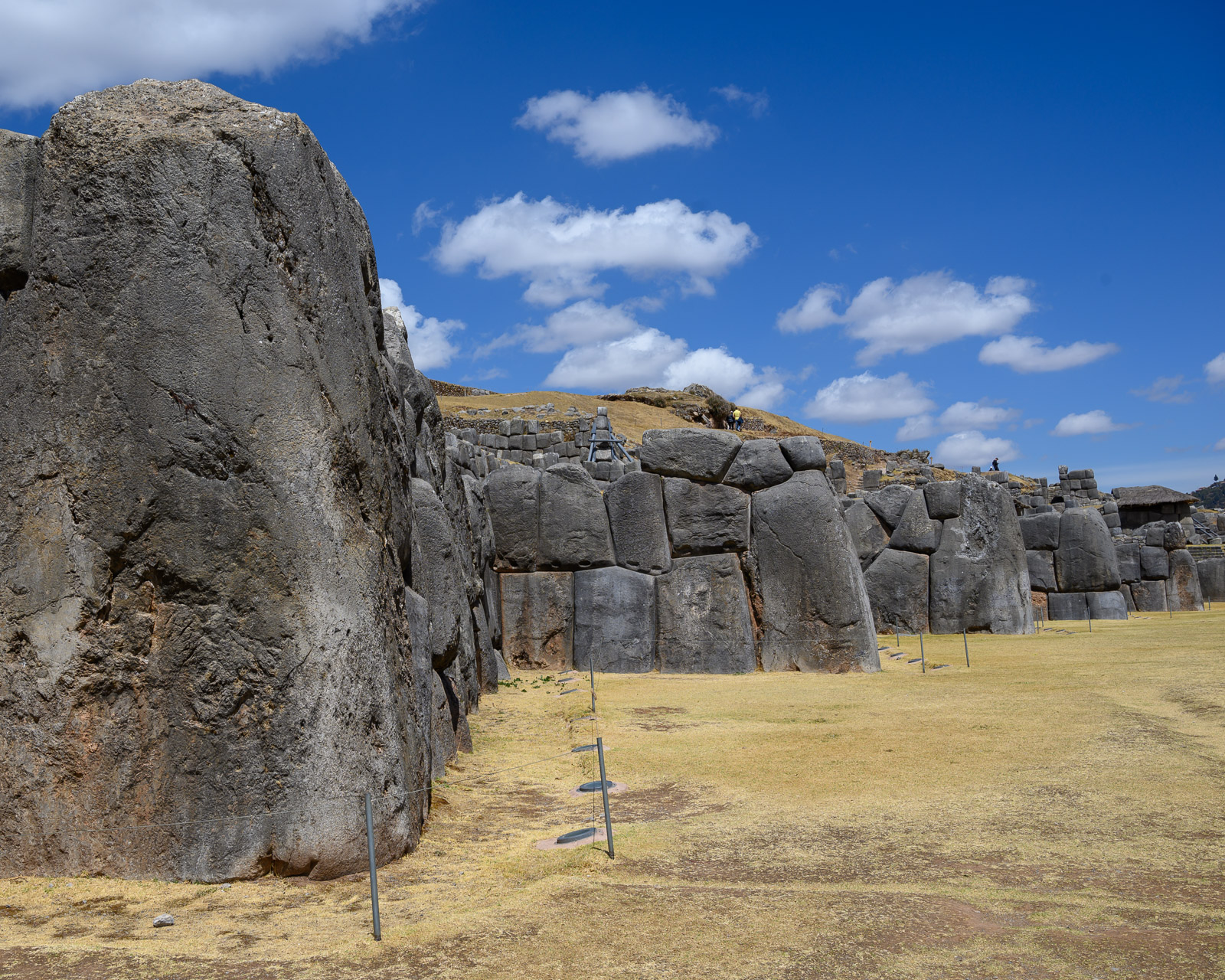 A wall of huge stones zig zags in front of SacsayhuamÃ¡n.