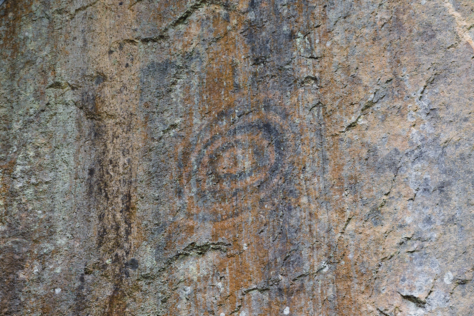 Faded round cliff marking on a rock face at the Inkaterra Machu Picchu Pueblo Hotel