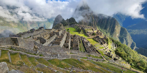 Wide angle view of Machu Picchu as the morning fog clears.