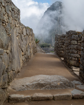 Misty view of Huayna Picchu after entering the City Gate at Machu Picchu.