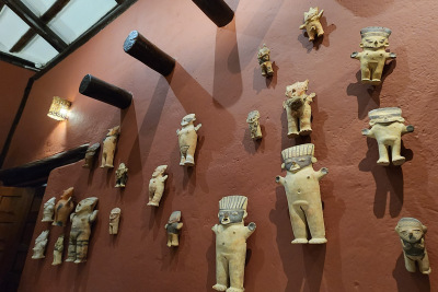 Terracotta figures from the Chancay culture decorate a wall at the Inkaterra Machu Picchu Pueblo Hotel.